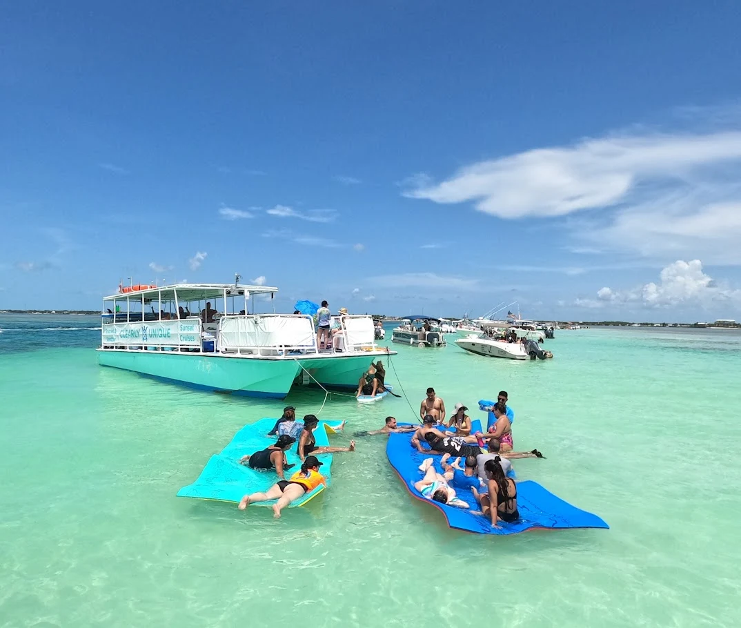 Group photo of people laying down on water mat at a sandbar in Islamorada Florida