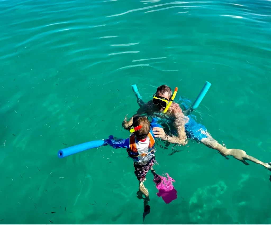 Father and son snorkeling together at Clearly Unique Charters