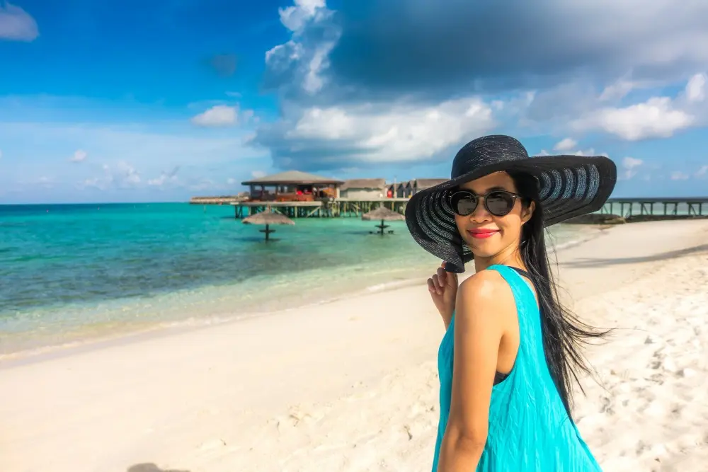 Portrait of happy young woman at beautiful water villa.