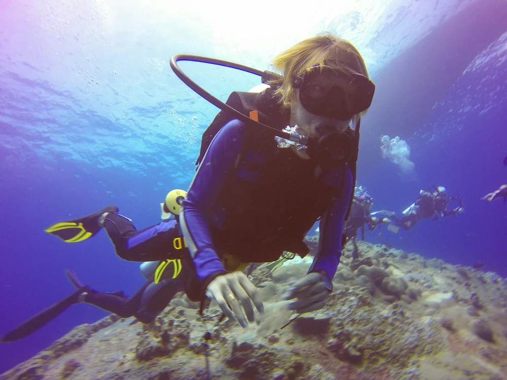 Snorkeler and scuba diver exploring underwater reef in Islamorada