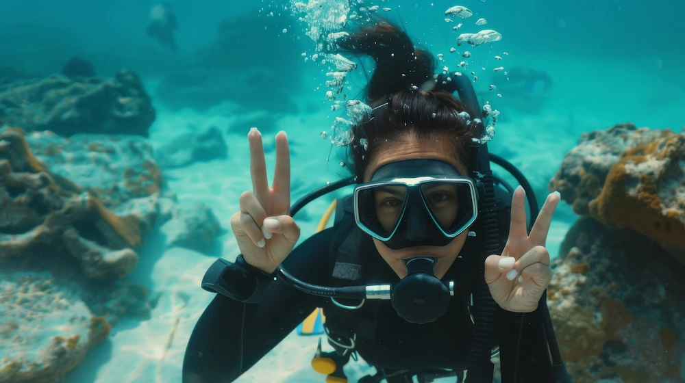 Snorkeler and scuba diver exploring underwater marine life