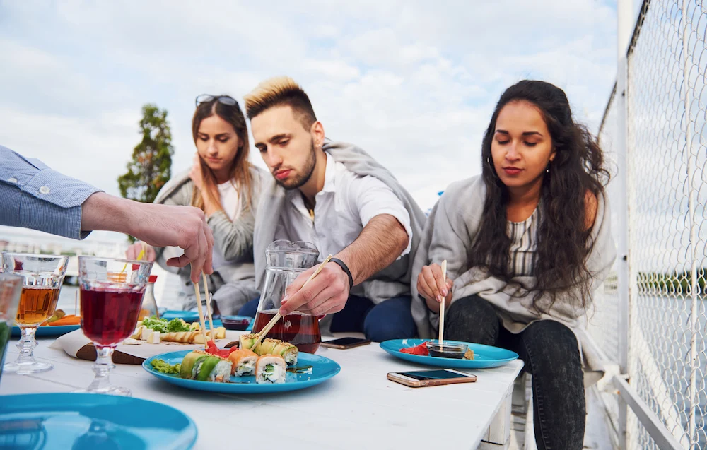 Guests relaxing on a boat with snacks and beverages