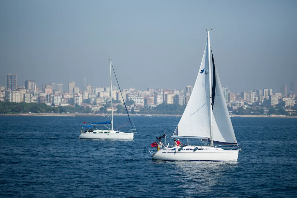 Modern catamaran cruising across calm blue water