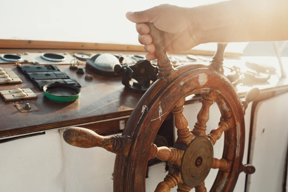 Boat captain navigating through clear waters near snorkeling areas