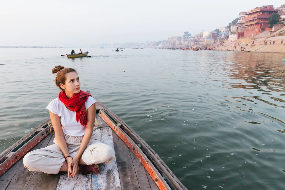 Couple enjoying a smooth boat ride while looking out at the ocean