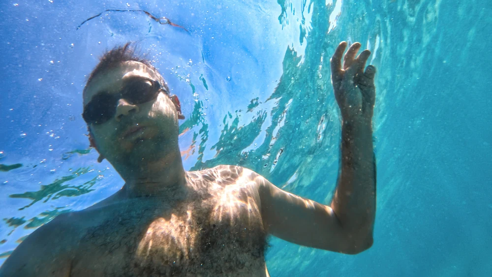 Person snorkeling in clear tropical waters during a guided tour
