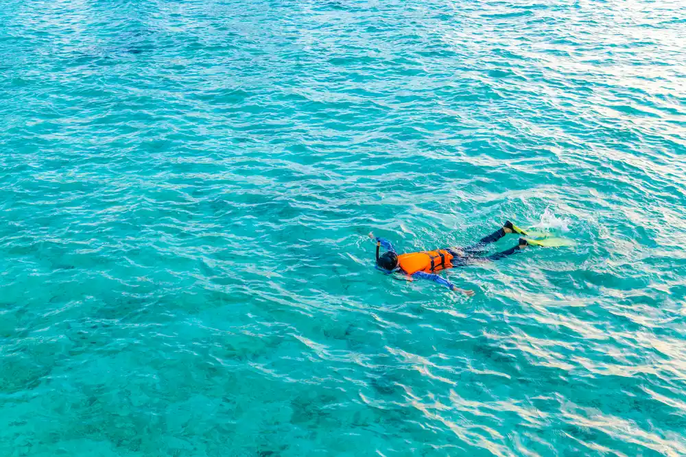 First-time snorkeler floating comfortably in calm clear water